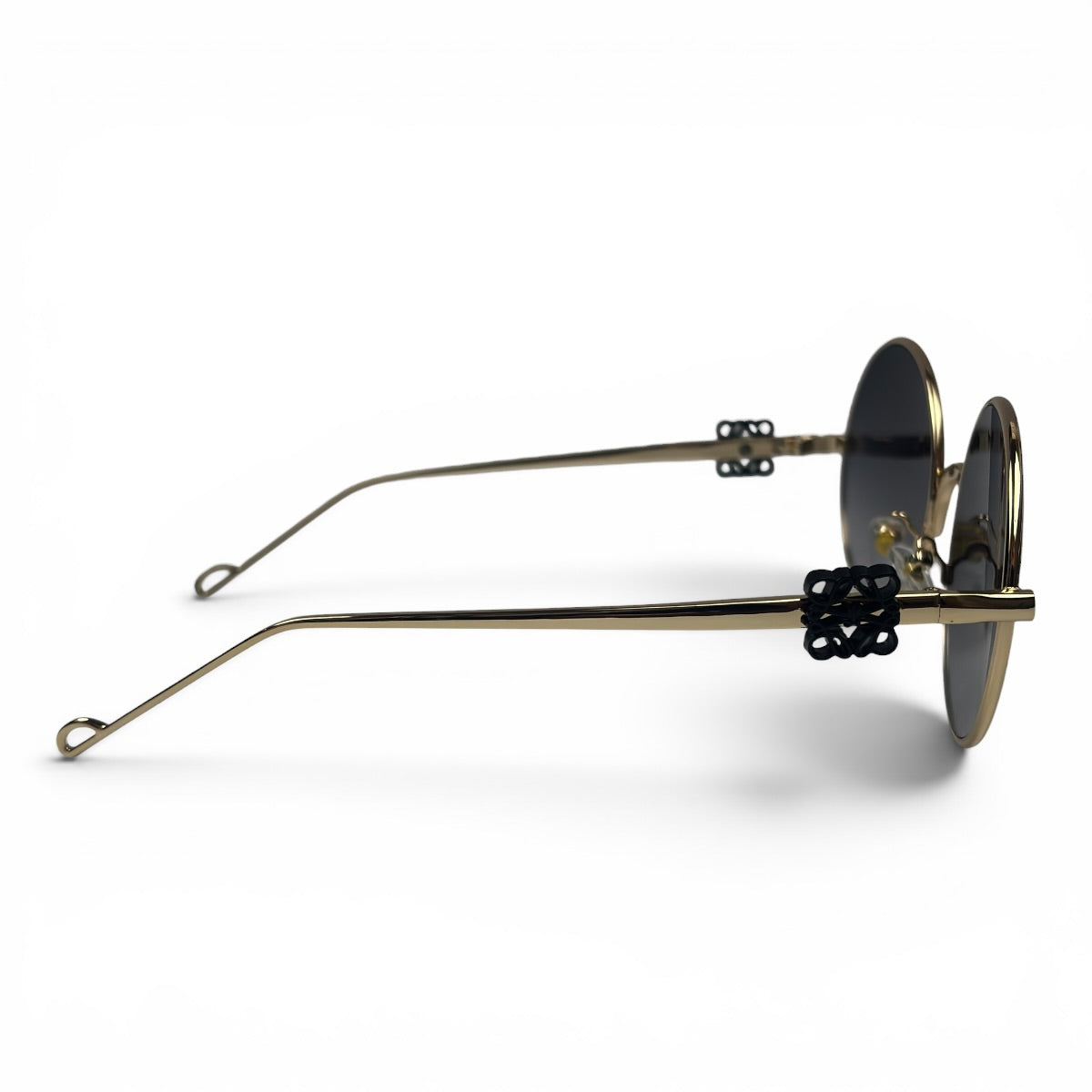 The Liora Round sunglasses in Gold with Dark Gray lenses, side profile view
