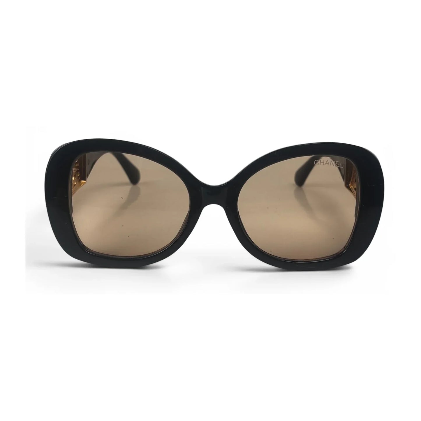 The Filigree oversized round sunglasses in black gold with brown lenses, front view