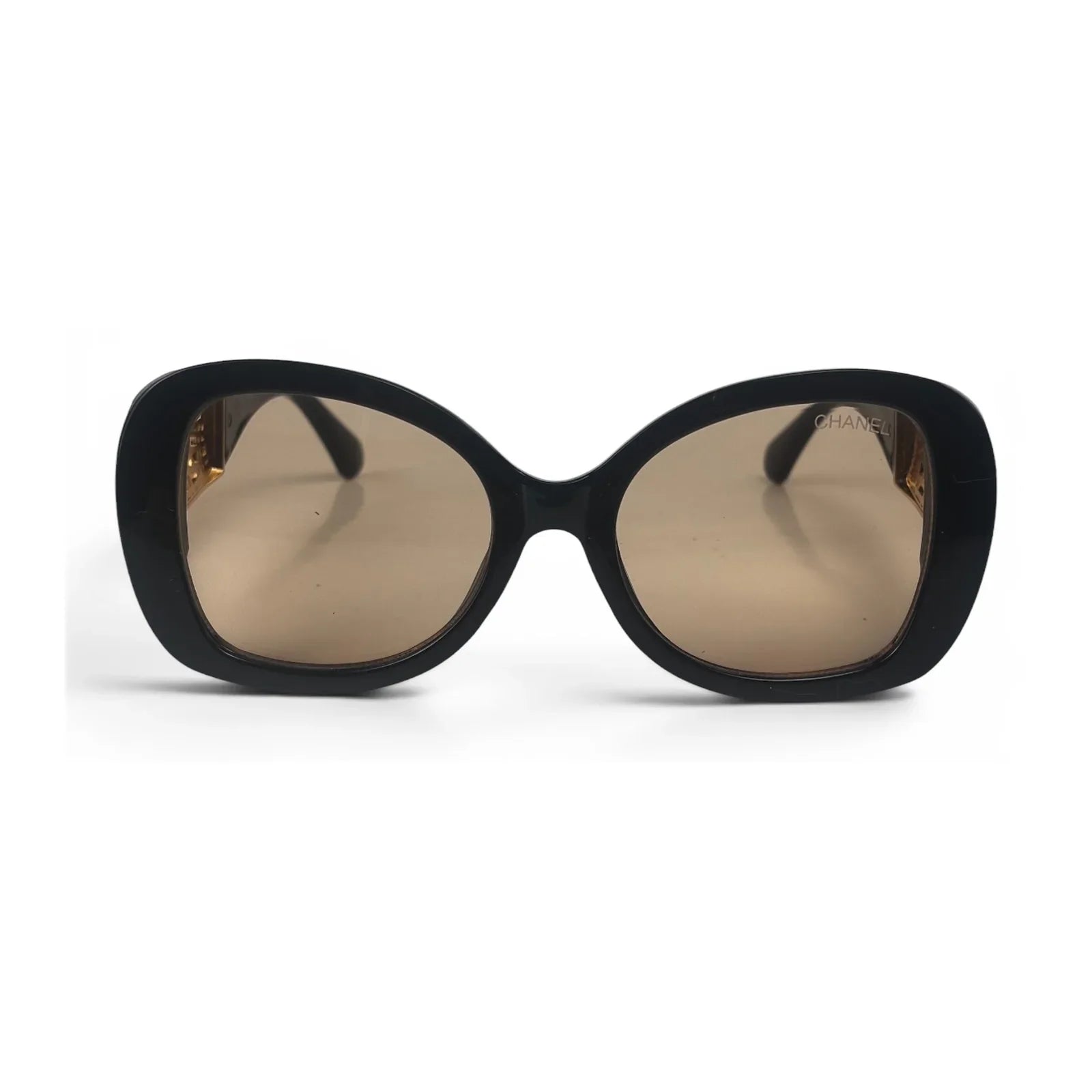 The Filigree oversized round sunglasses in black gold with brown lenses, front view