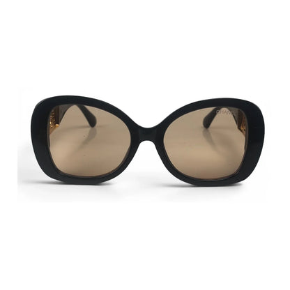 The Filigree oversized round sunglasses in black gold with brown lenses, front view