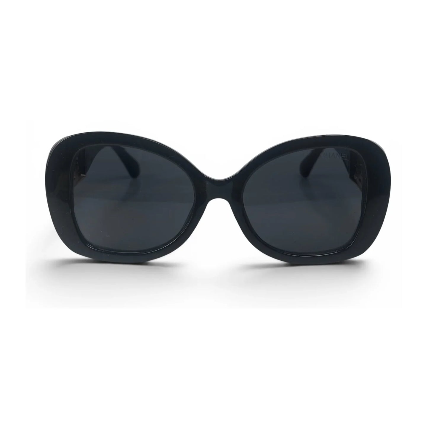 The Filigree oversized round sunglasses in black gold with dark gray lenses, front view