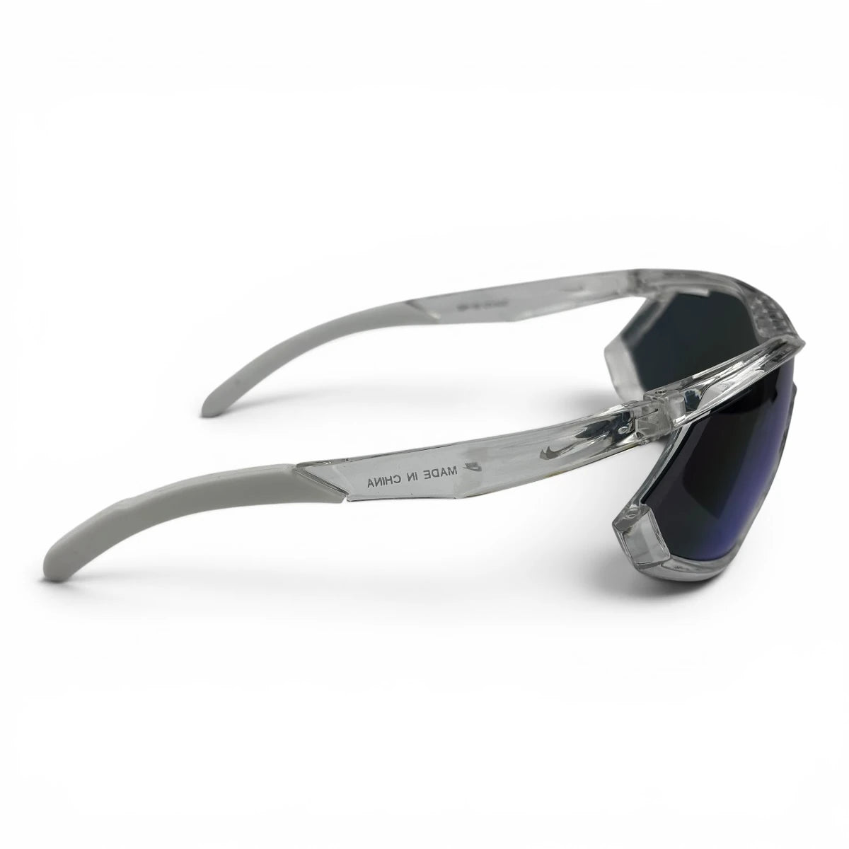 The Glide Sport Shield sunglasses in Clear with Blue Mirror lenses, side profile view