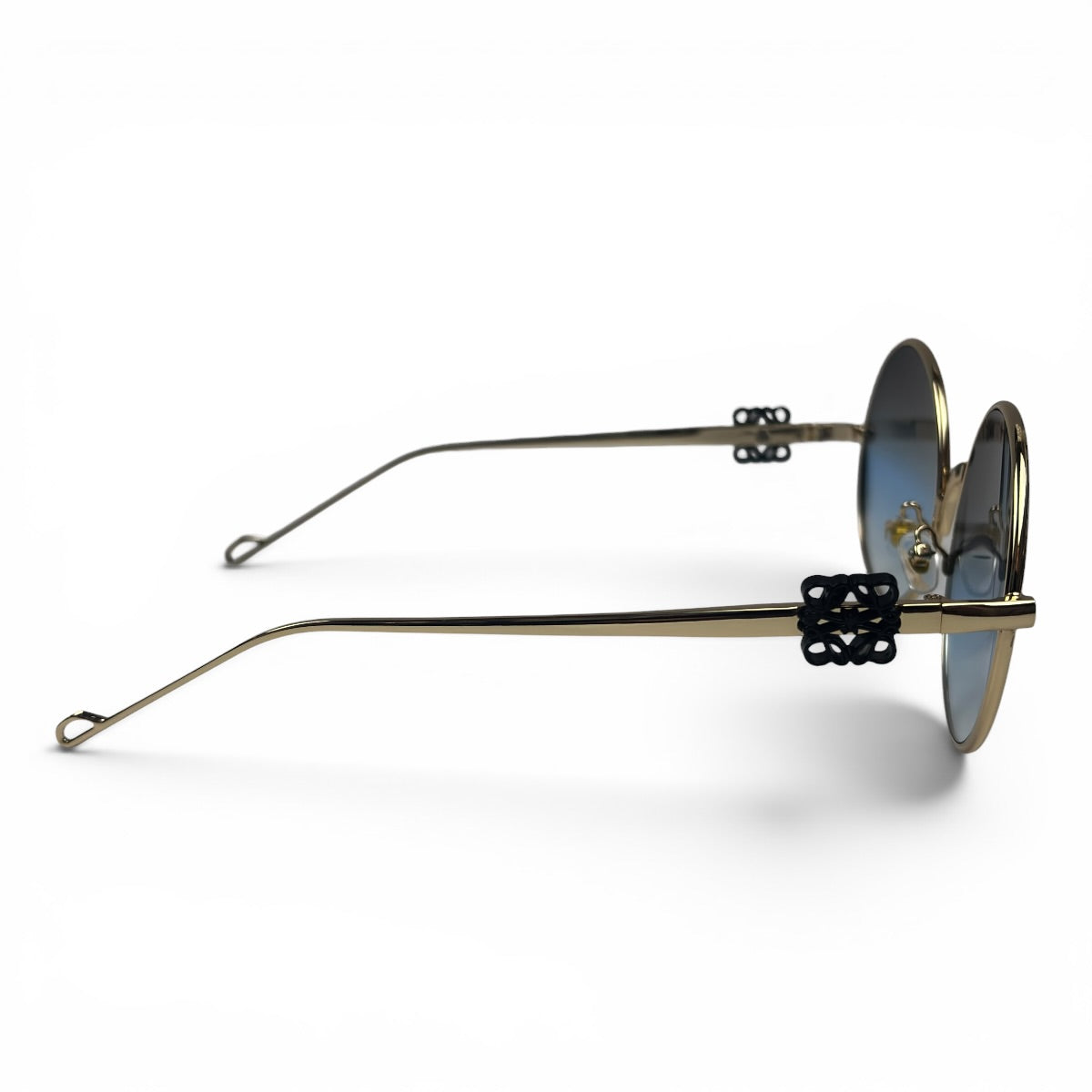 The Liora Round sunglasses in Gold with Blue Gradient lenses, side profile view