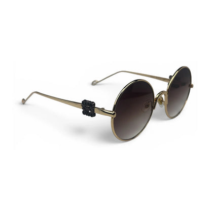 The Liora Round sunglasses in Gold with Brown Gradient lenses, angled three-quarter view