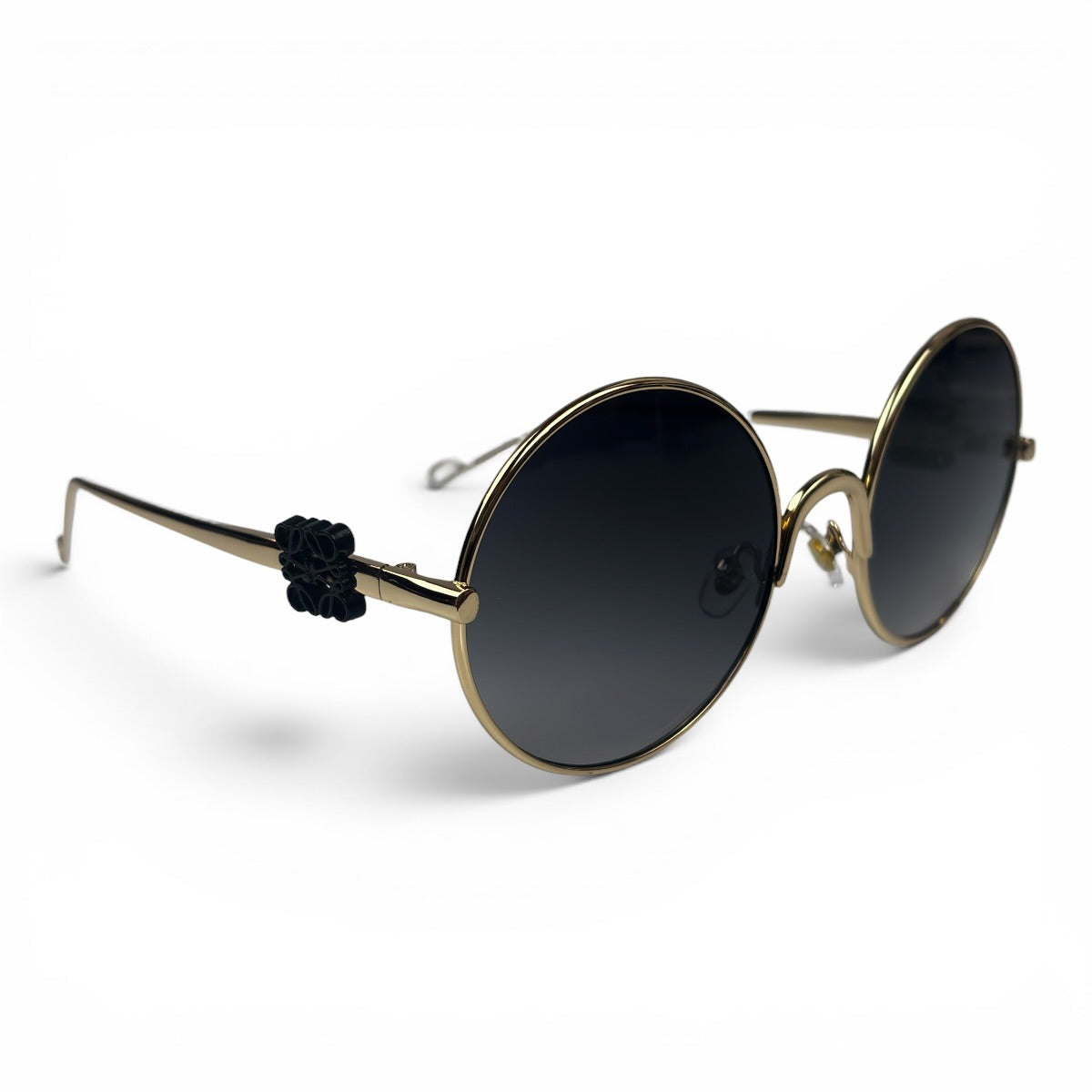The Liora Round sunglasses in Gold with Dark Gray lenses, angled three-quarter view