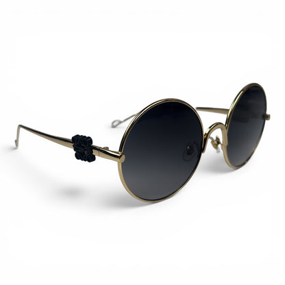 The Liora Round sunglasses in Gold with Dark Gray lenses, angled three-quarter view