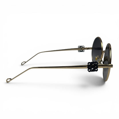 The Liora Round sunglasses in Gold with Dark Gray lenses, side profile view