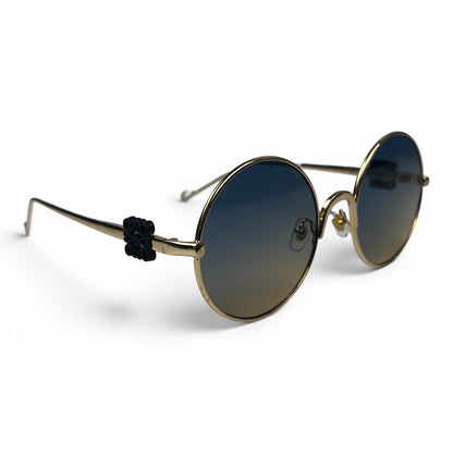 The Liora Round sunglasses in Gold with Green Gray lenses, angled three-quarter view