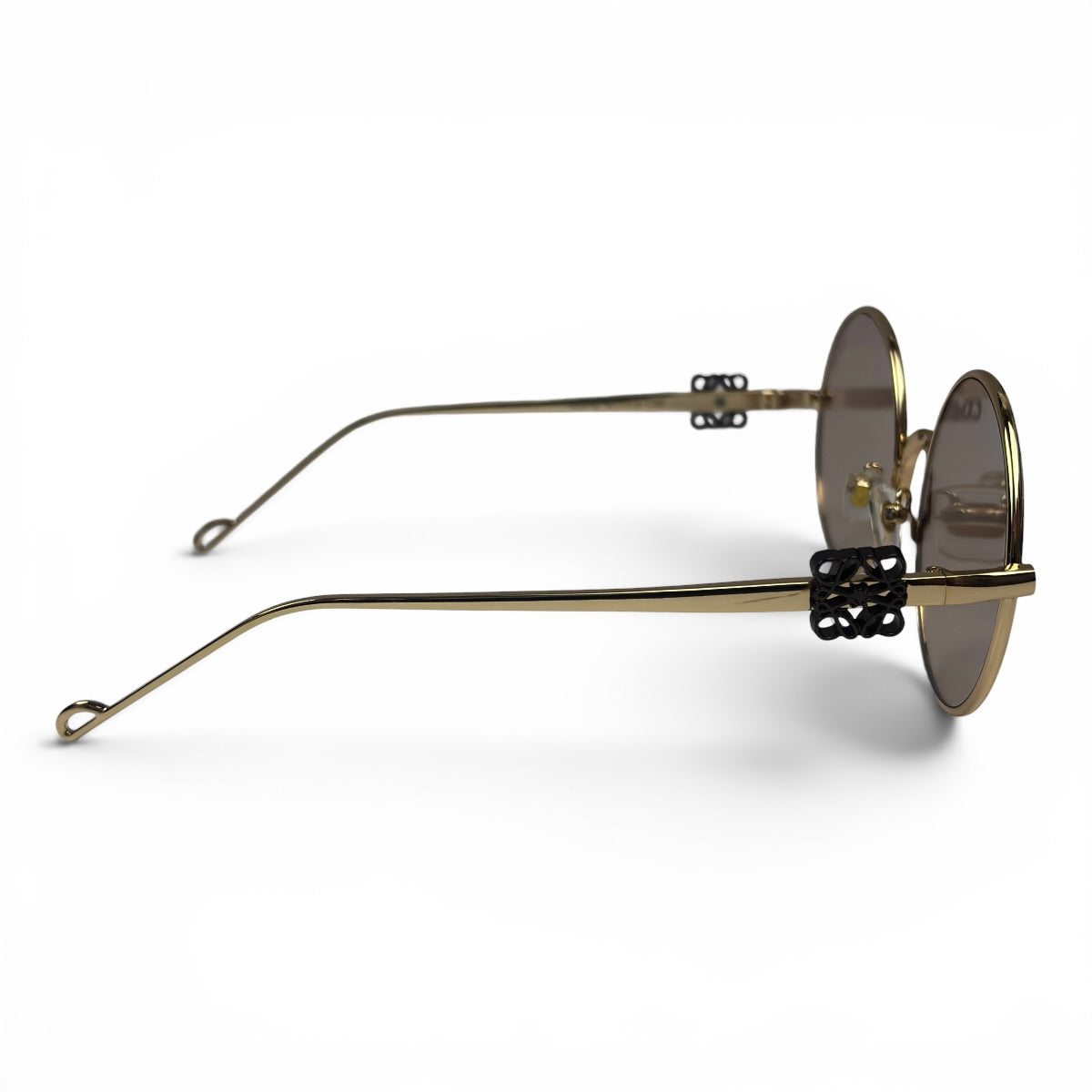 The Liora Round sunglasses in Gold with Taupe lenses, side profile view
