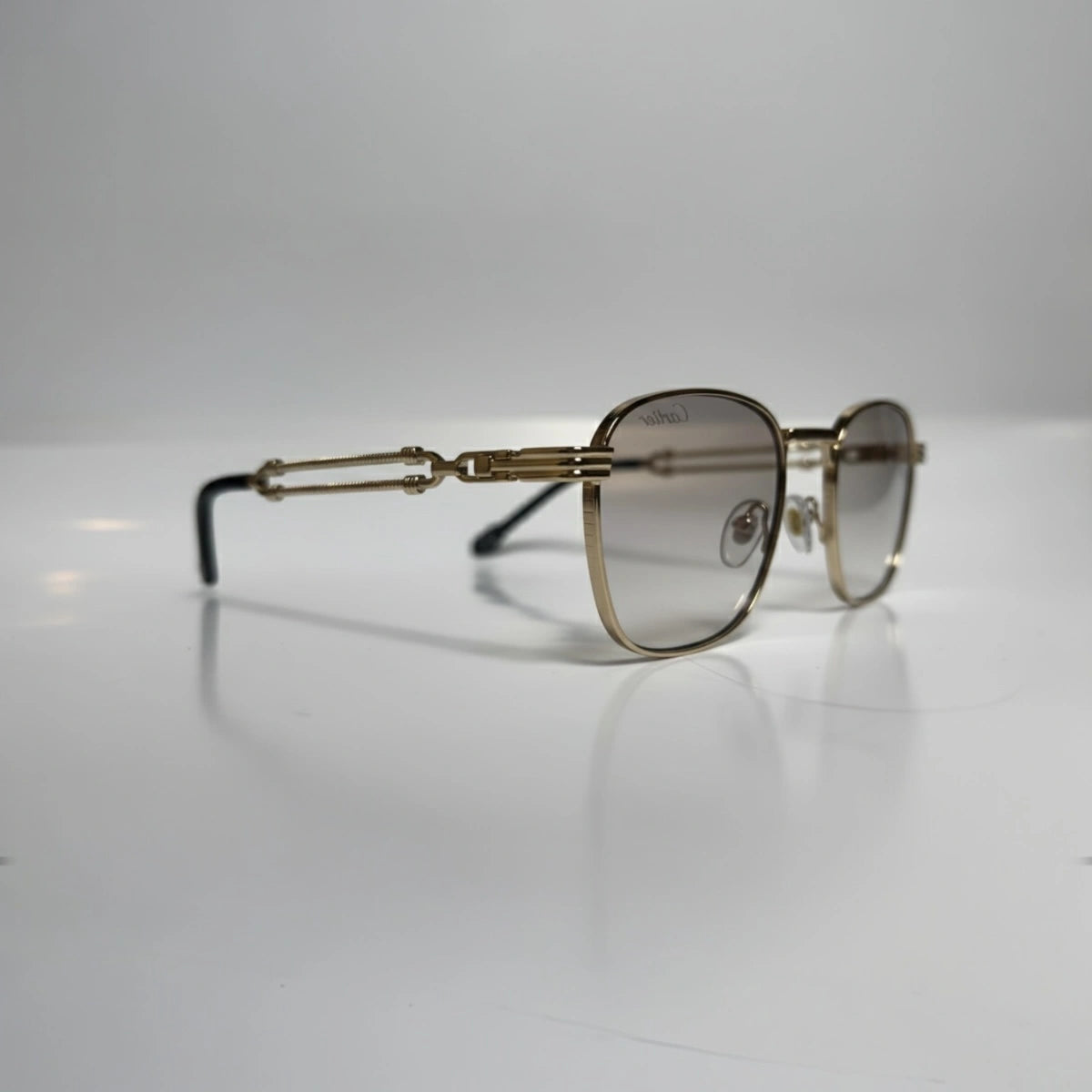 Transparent gold rectangle sunglasses with brown gradient lenses, angled view