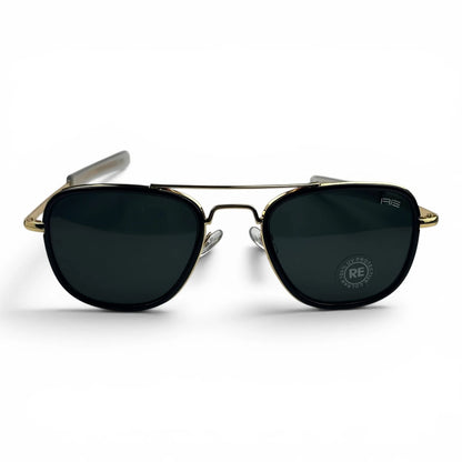 The Rayan Metal Rectangle sunglasses in Gold and Black with Black lenses, angled three-quarter view