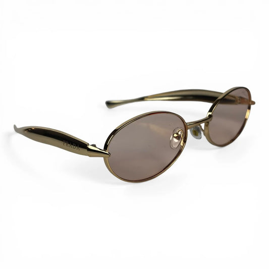 The Aveline oval sunglasses in gold with taupe lenses, angled three-quarter view
