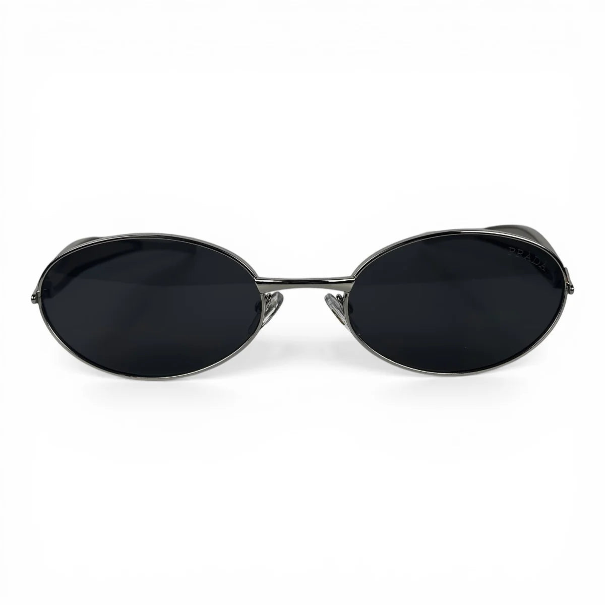 The Aveline oval sunglasses in silver with black lenses, straight front view