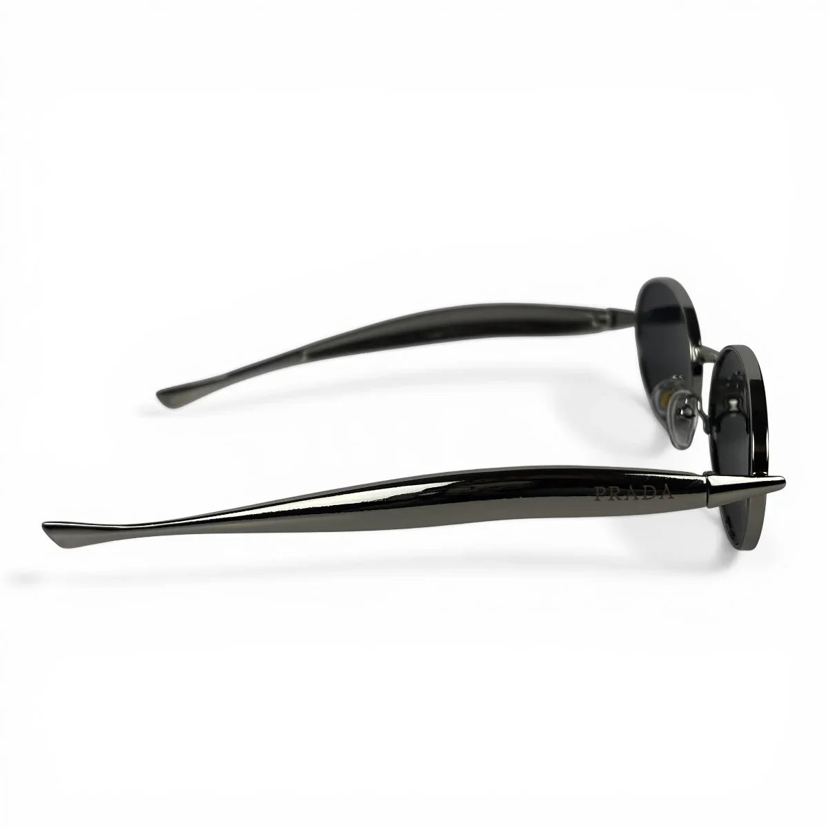 The Aveline oval sunglasses in silver with black lenses, side profile view