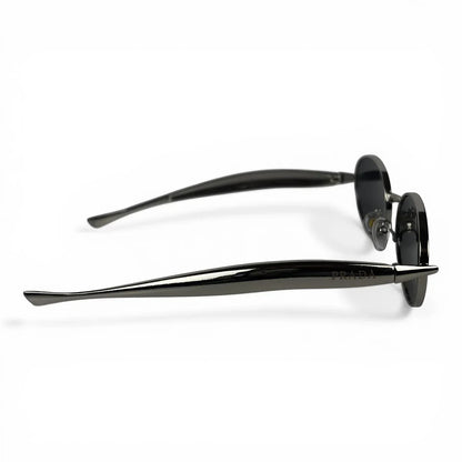 The Aveline oval sunglasses in silver with black lenses, side profile view