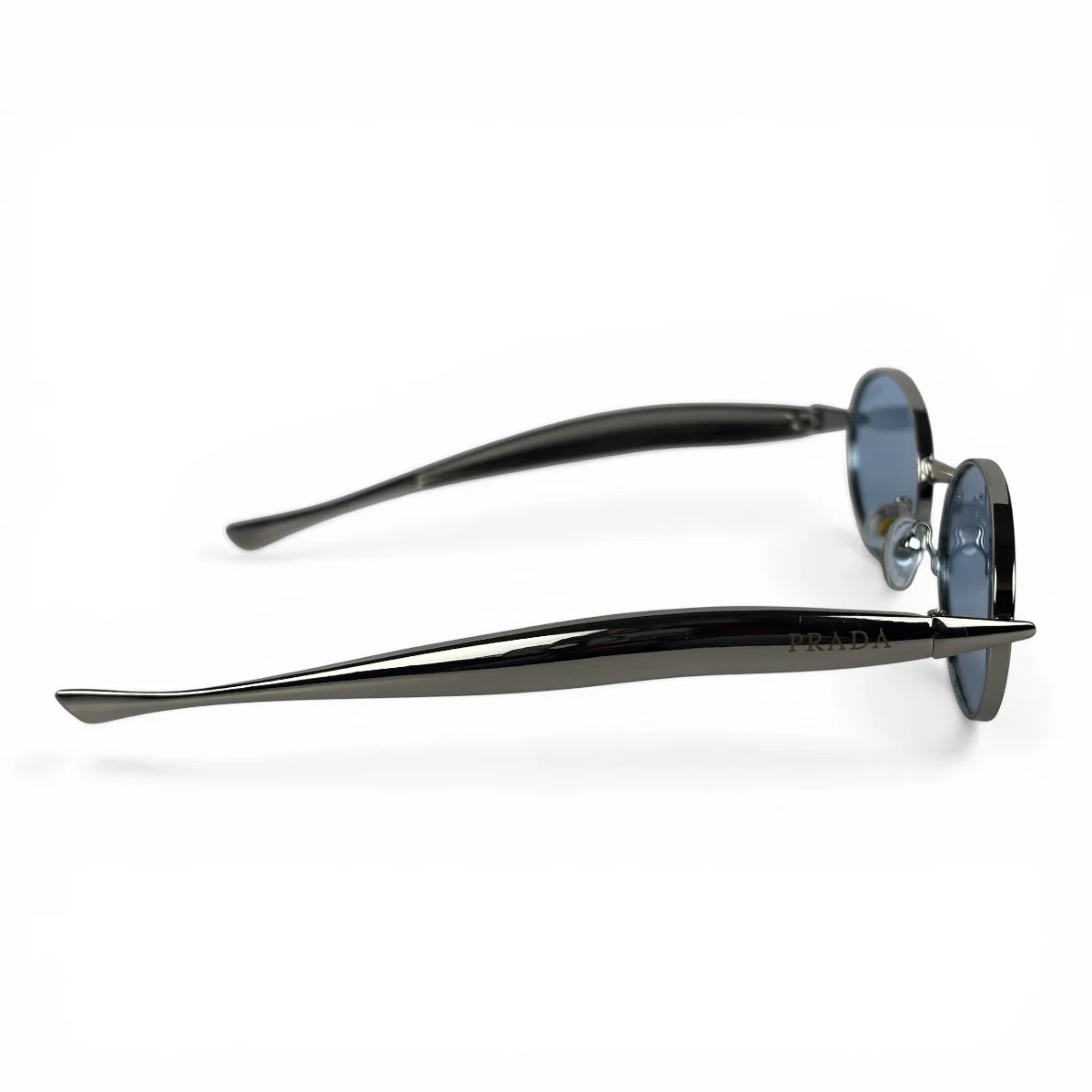 The Aveline oval sunglasses in silver with blue lenses, side profile view