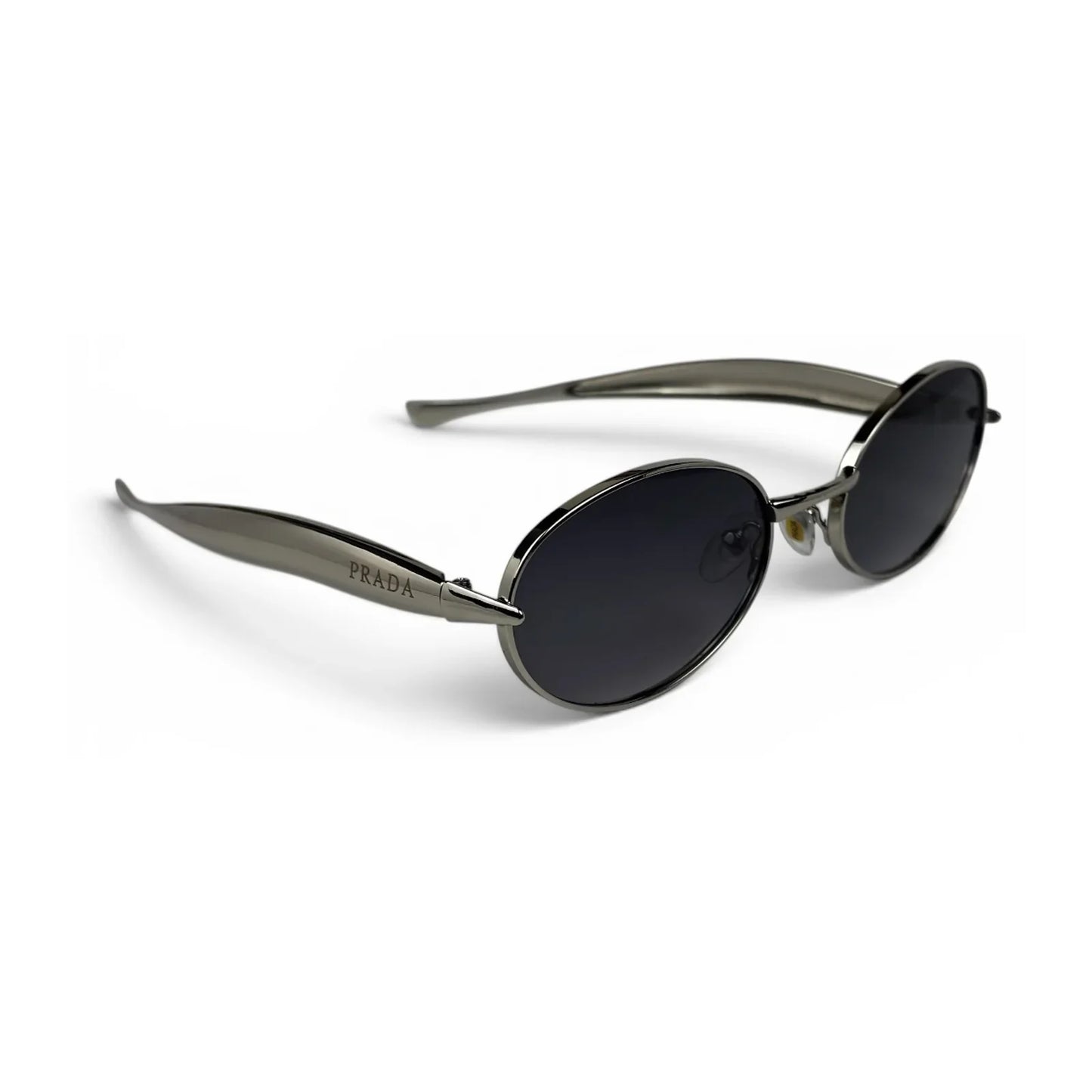 The Aveline oval sunglasses in silver with black lenses, angled three-quarter view