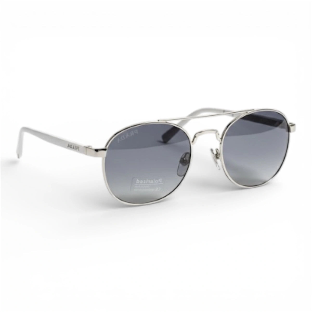 Silver round double-bridge sunglasses with gray gradient lenses, angled view