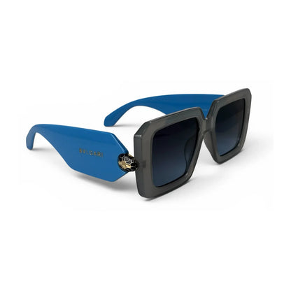 U&Eye The Vesper shield-square sunglasses with smoke gray frame and blue temple detail, angled view